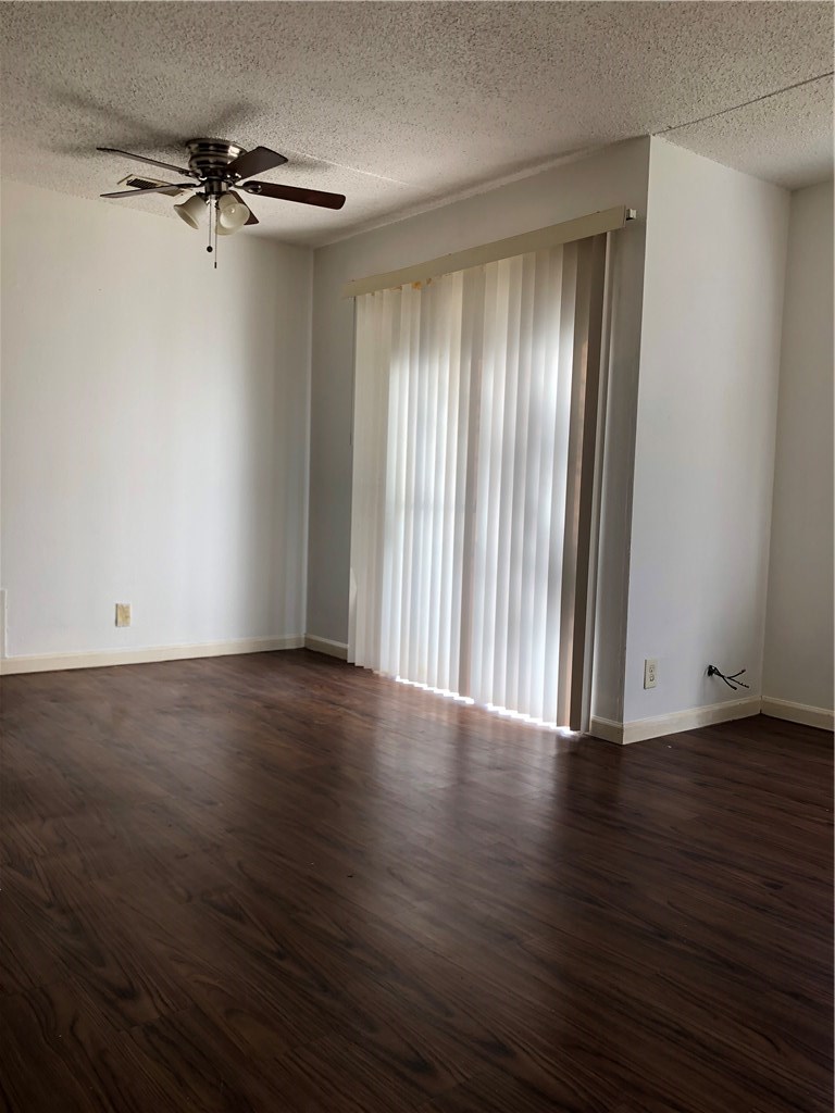 6500 South 1st Street, Unit 103 Austin, TX 78745 - Photo 15 of 25 a view of a room with wooden floor and a window