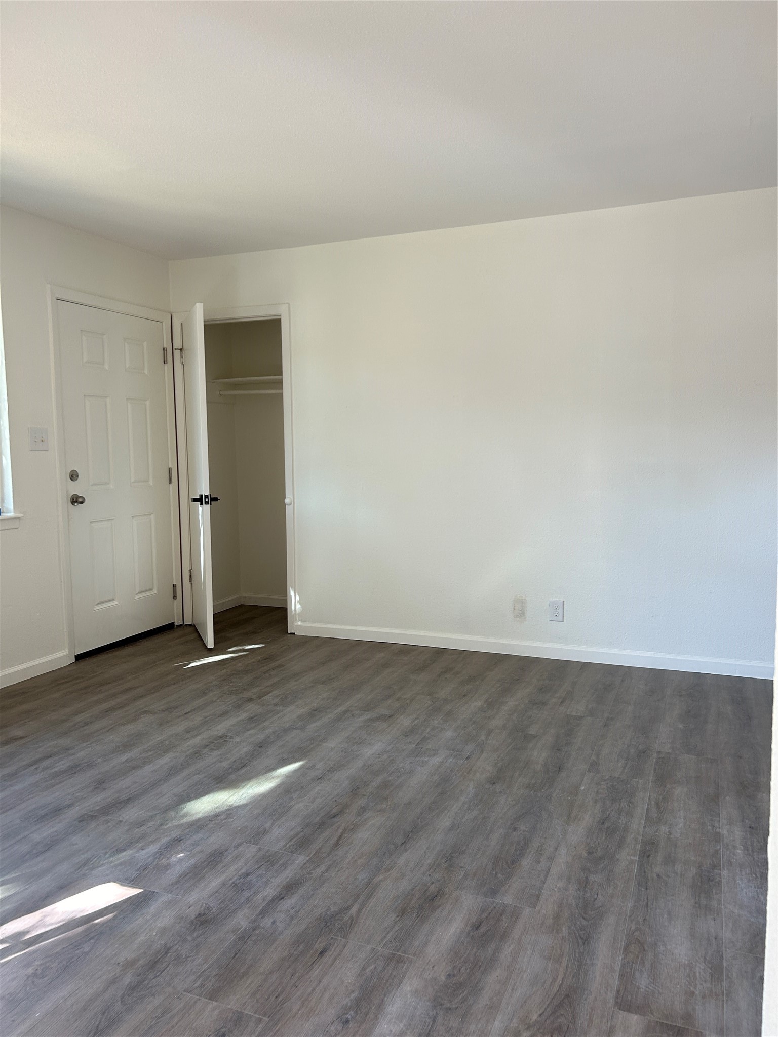 6500 South 1st Street, Unit 103 Austin, TX 78745 - Photo 10 of 25 a view of an empty room with wooden floor