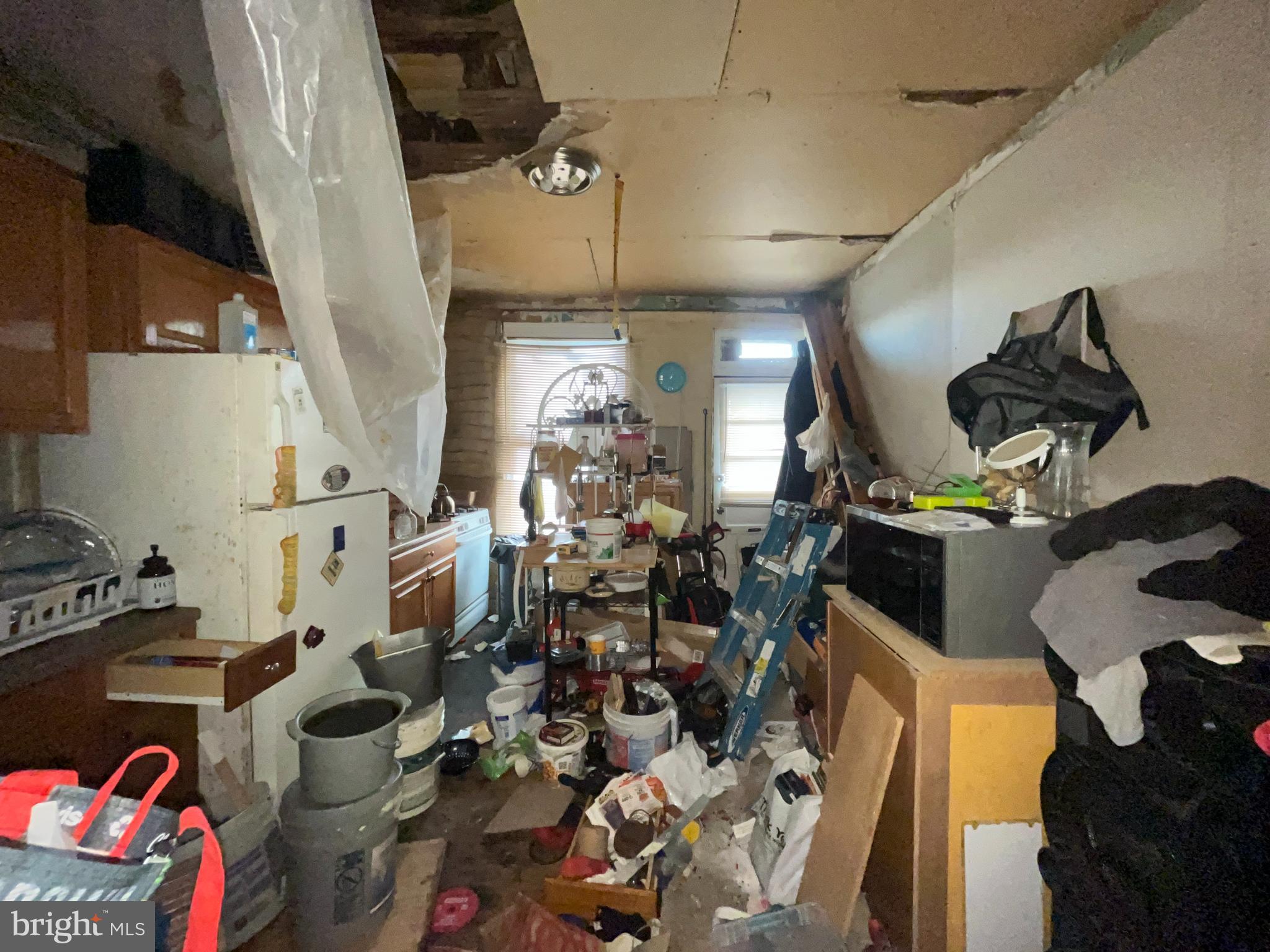 1508 Cliftview Avenue Baltimore, MD 21213 - Photo 7 of 18 a kitchen with lots of clutter and appliances