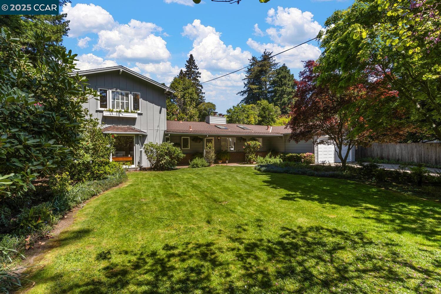 a front view of house with yard and green space