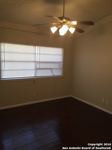7923 Donore Place, Unit 12 San Antonio, TX 78229 - Photo 4 of 9 a view of a room with wooden floor and a window