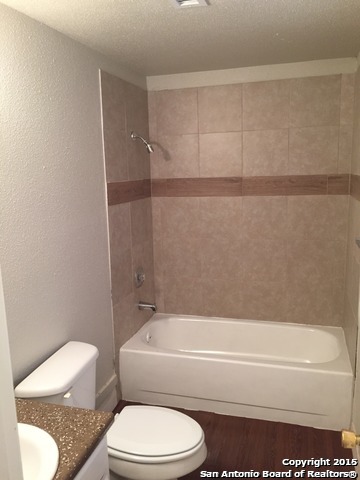 7923 Donore Place, Unit 12 San Antonio, TX 78229 - Photo 7 of 9 a bathroom with a toilet and a bathtub