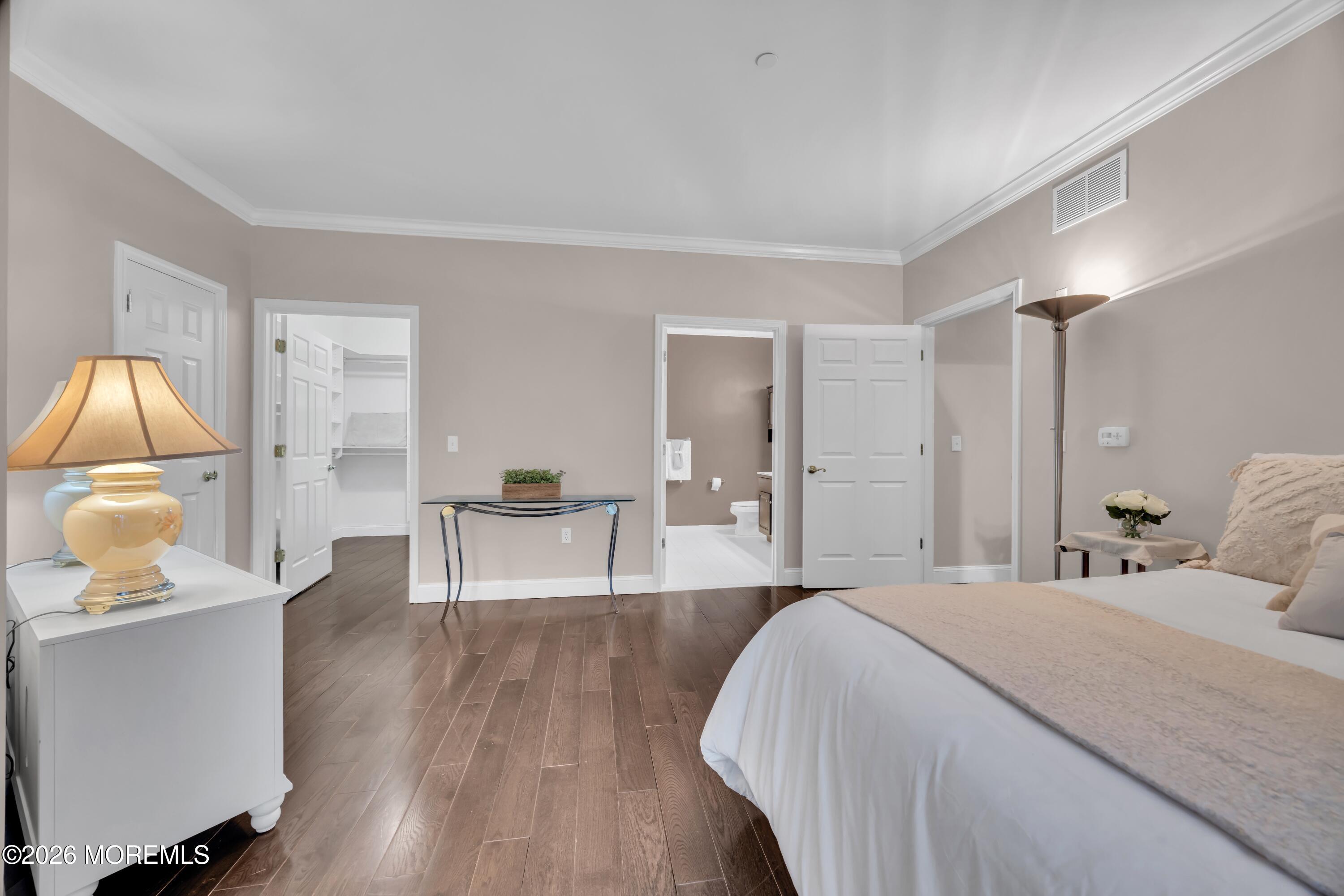 540 Cranbury Road, Unit 219 East Brunswick, NJ 08816 - Photo 15 of 39 a spacious bedroom with a bed and a wooden floor