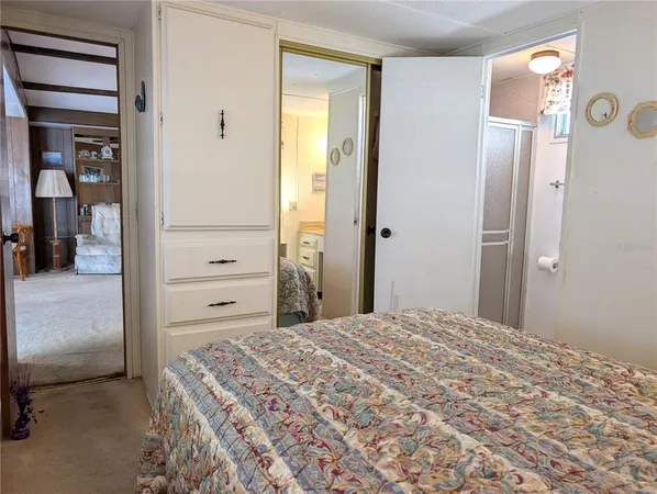 a white toilet sitting next to a shower