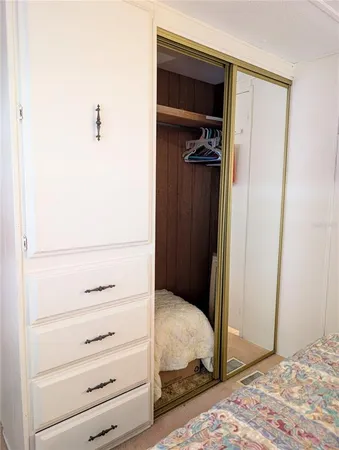 a bedroom with a bed and a mirror