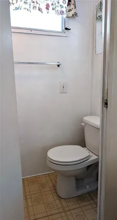 a bedroom with furniture and a large window