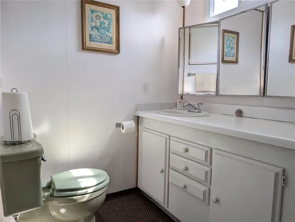 a living room with furniture pool table kitchen view and a chandelier