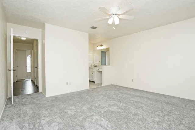 wooden floor in an empty room and a bathroom