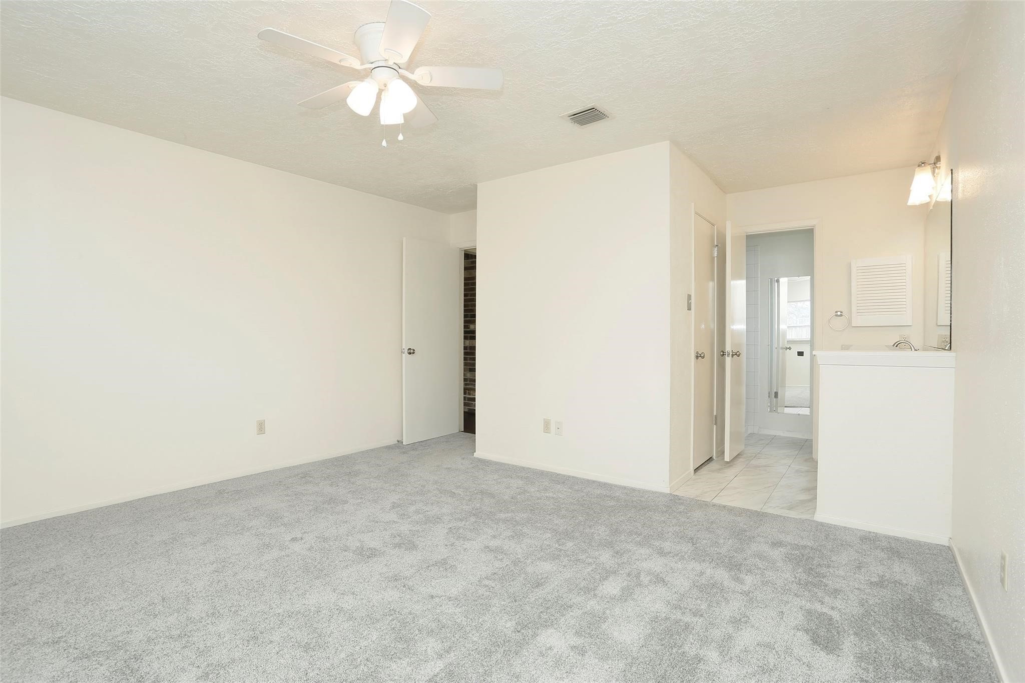 1418 Crawley Court Channelview, TX 77530 - Photo 13 of 23 an empty room with fan and entrance