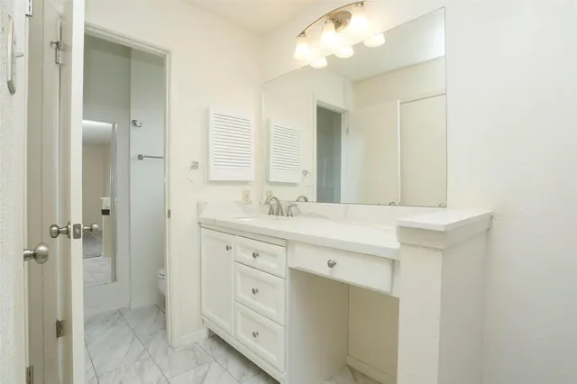a bathroom with a granite countertop sink mirror and double
