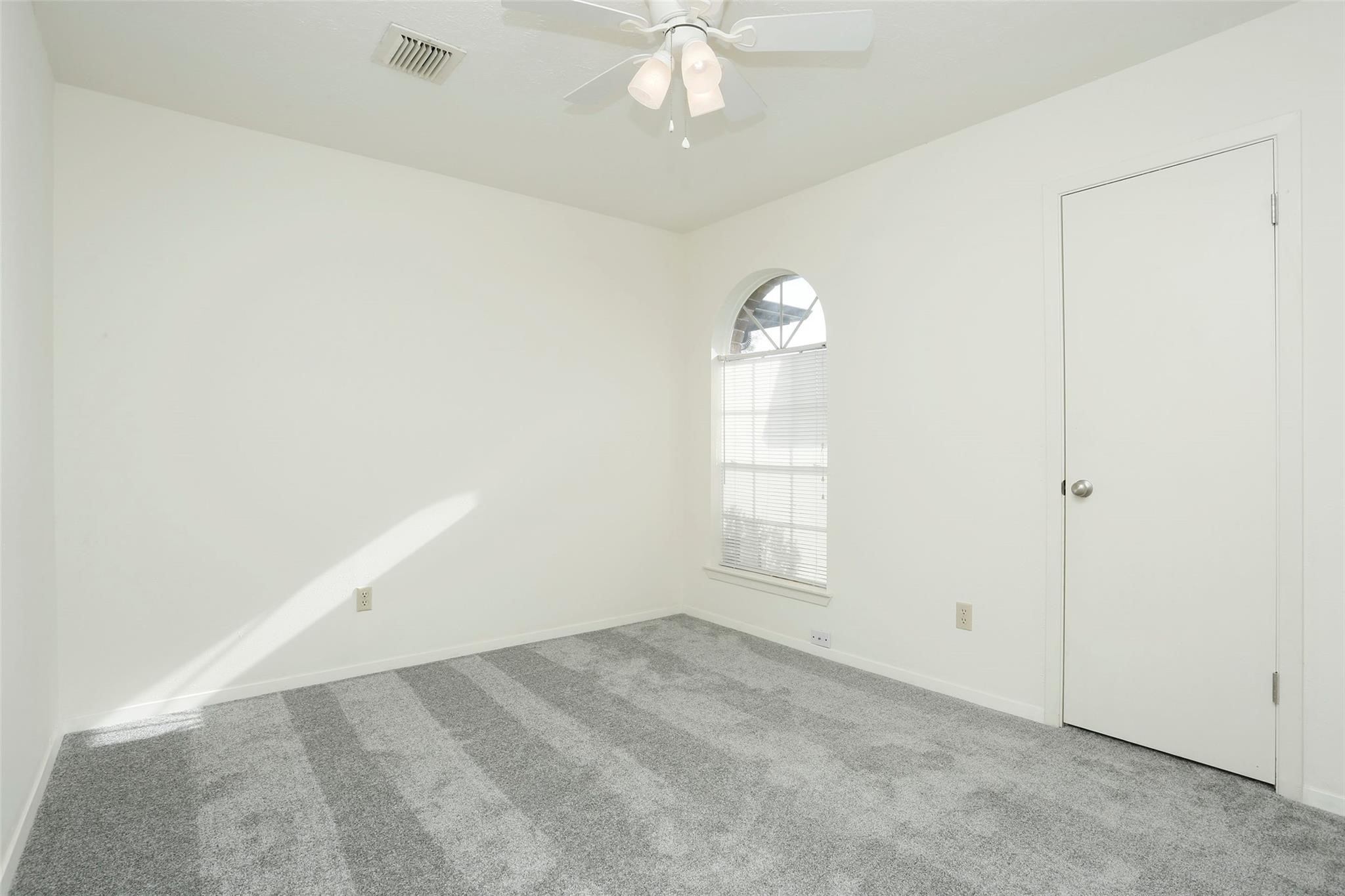 1418 Crawley Court Channelview, TX 77530 - Photo 15 of 23 an empty room with windows and ceiling fan