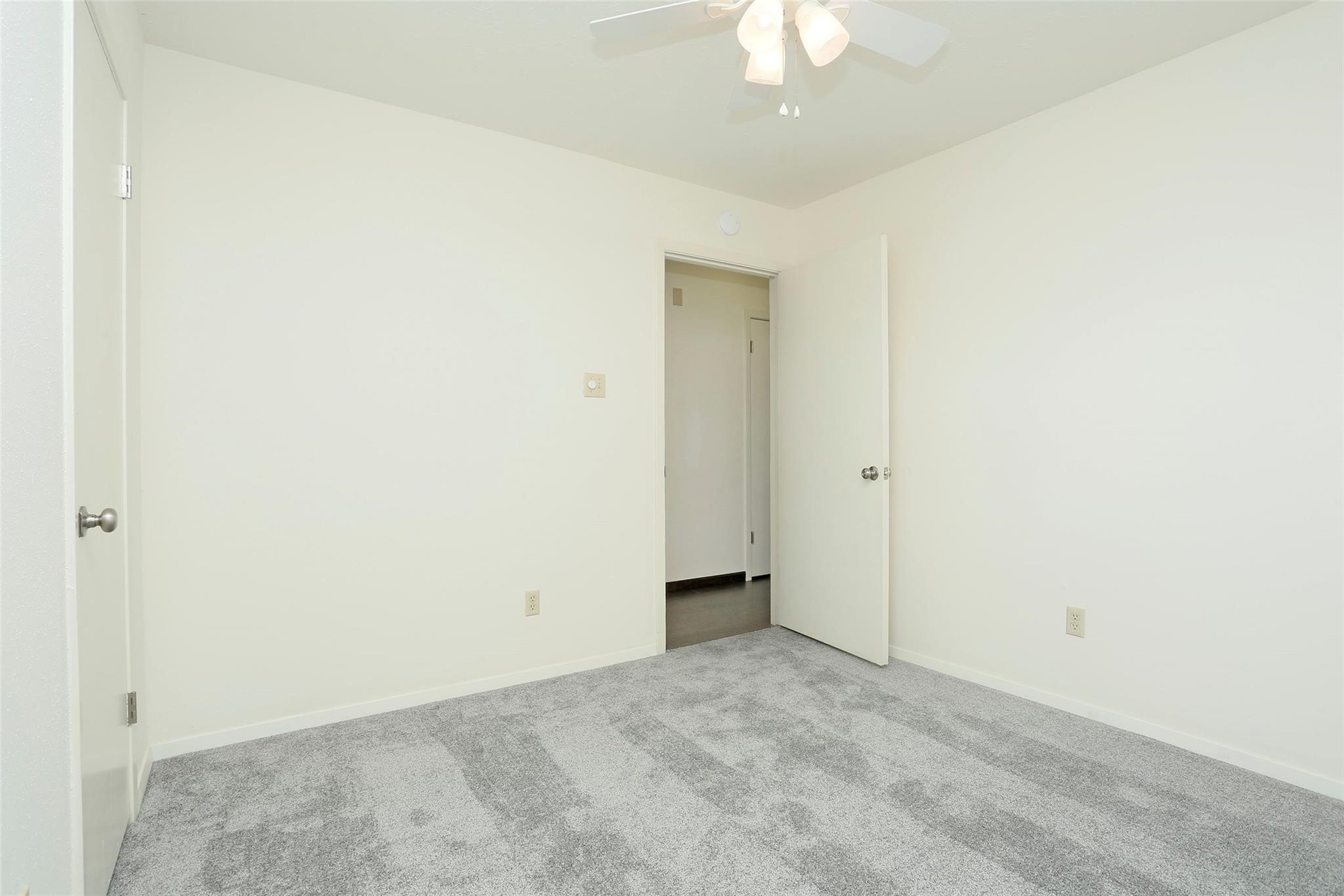 1418 Crawley Court Channelview, TX 77530 - Photo 17 of 23 an empty room with a chandelier fan and closet area