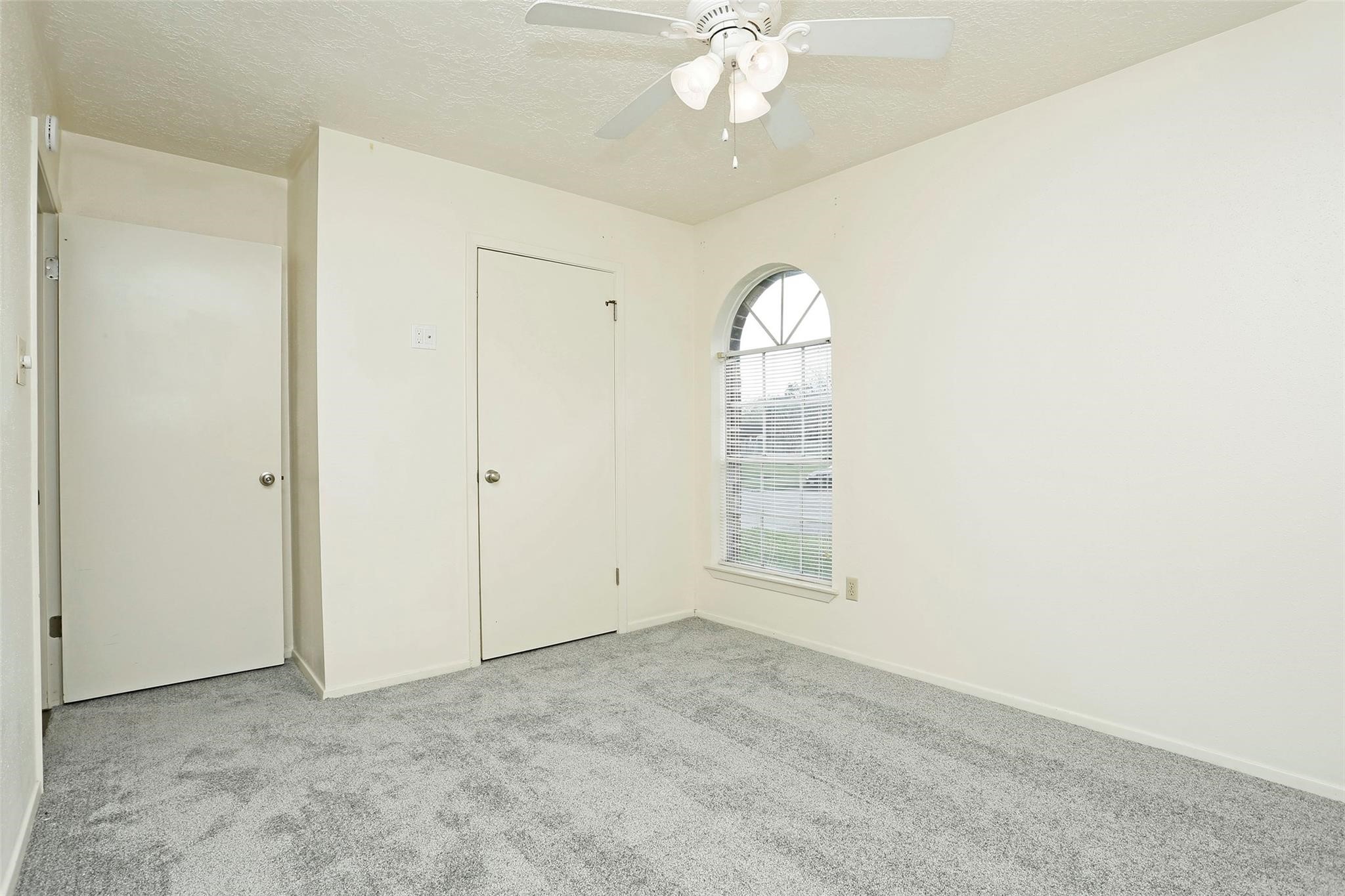 1418 Crawley Court Channelview, TX 77530 - Photo 19 of 23 an empty room with a chandelier fan and windows