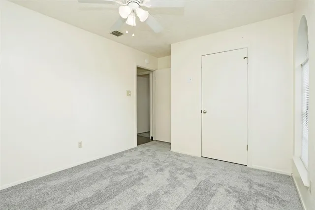 an empty room with a ceiling fan