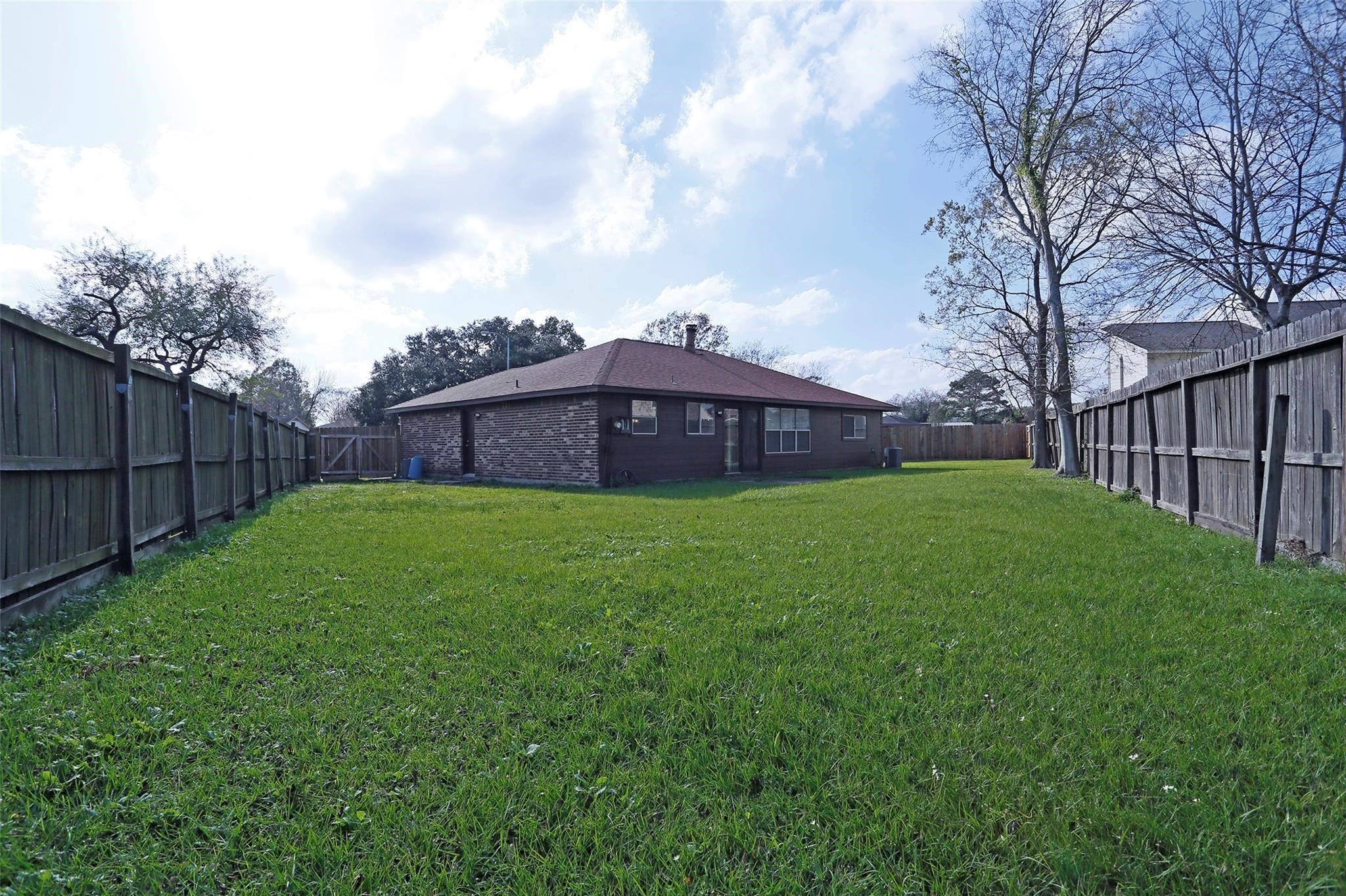 1418 Crawley Court Channelview, TX 77530 - Photo 22 of 23 a view of a garden with a large tree