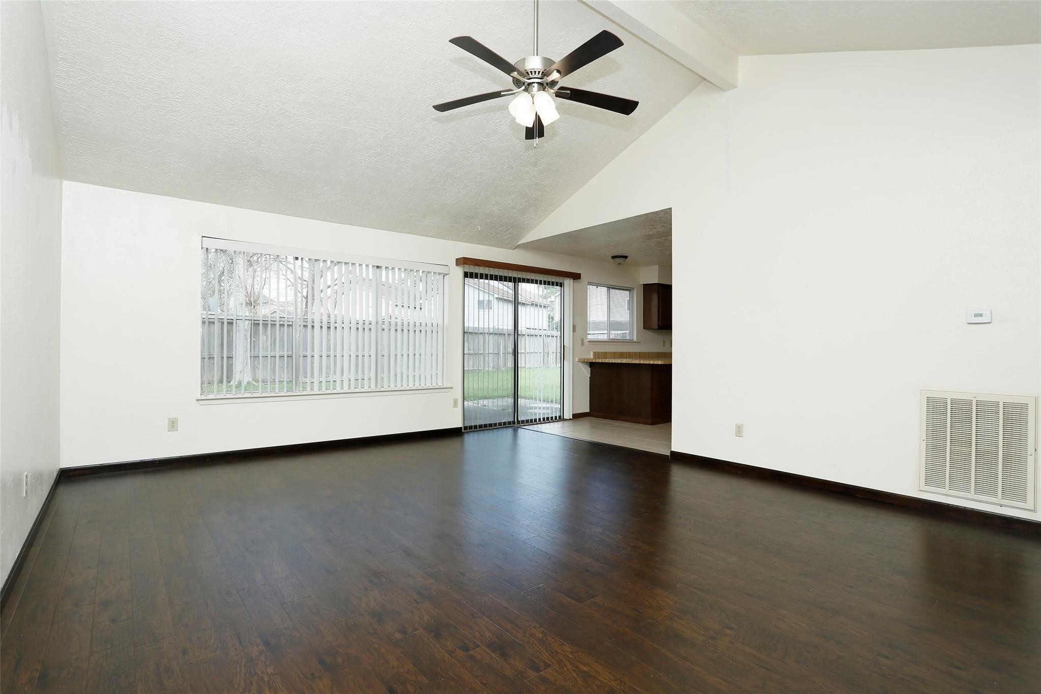 1418 Crawley Court Channelview, TX 77530 - Photo 4 of 23 an empty room with wooden floor and windows