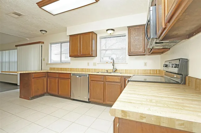 a kitchen with stainless steel appliances granite countertop a sink and cabinets