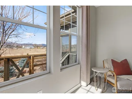 a bedroom with a bed a mirror and lamp