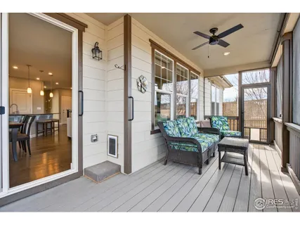 a view of a hallway with a dining table chairs and white cabinets