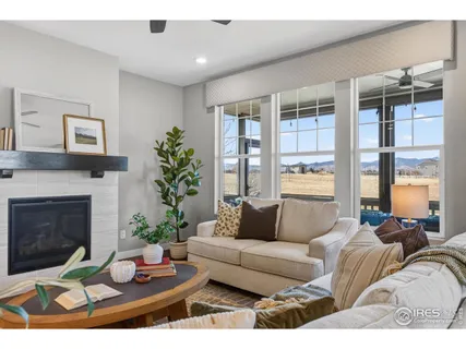 a living room with furniture kitchen and a table