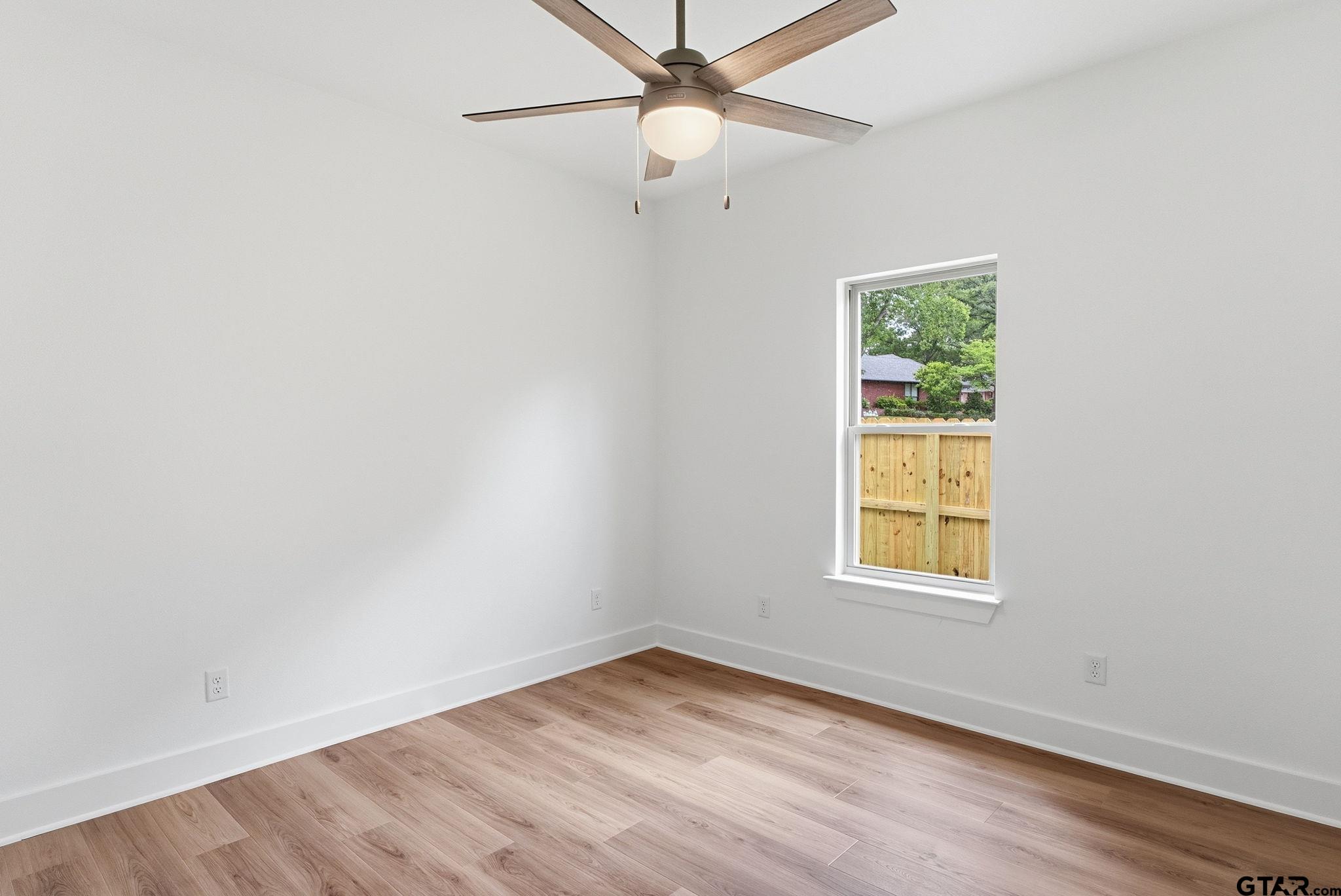 2968 Calloway Road Tyler, TX 75701 - Photo 16 of 24 an empty room with a window and a fan