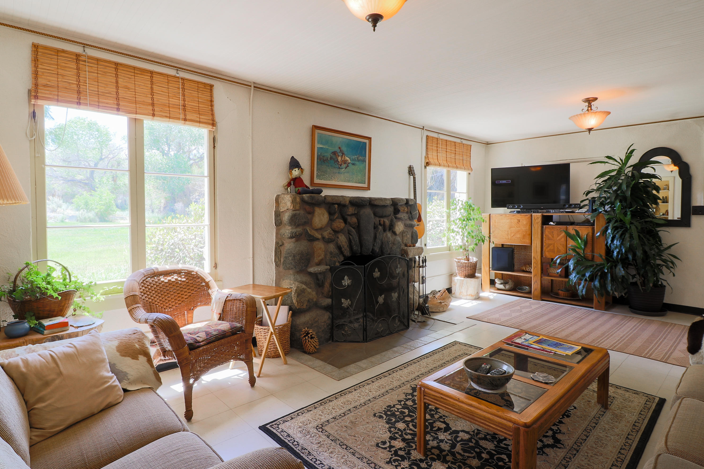 30666 Valyermo Road Llano, CA 93544 - Photo 54 of 88 a living room with furniture a flat screen tv and a fireplace
