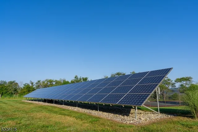 a view of a big house with many windows and a yard