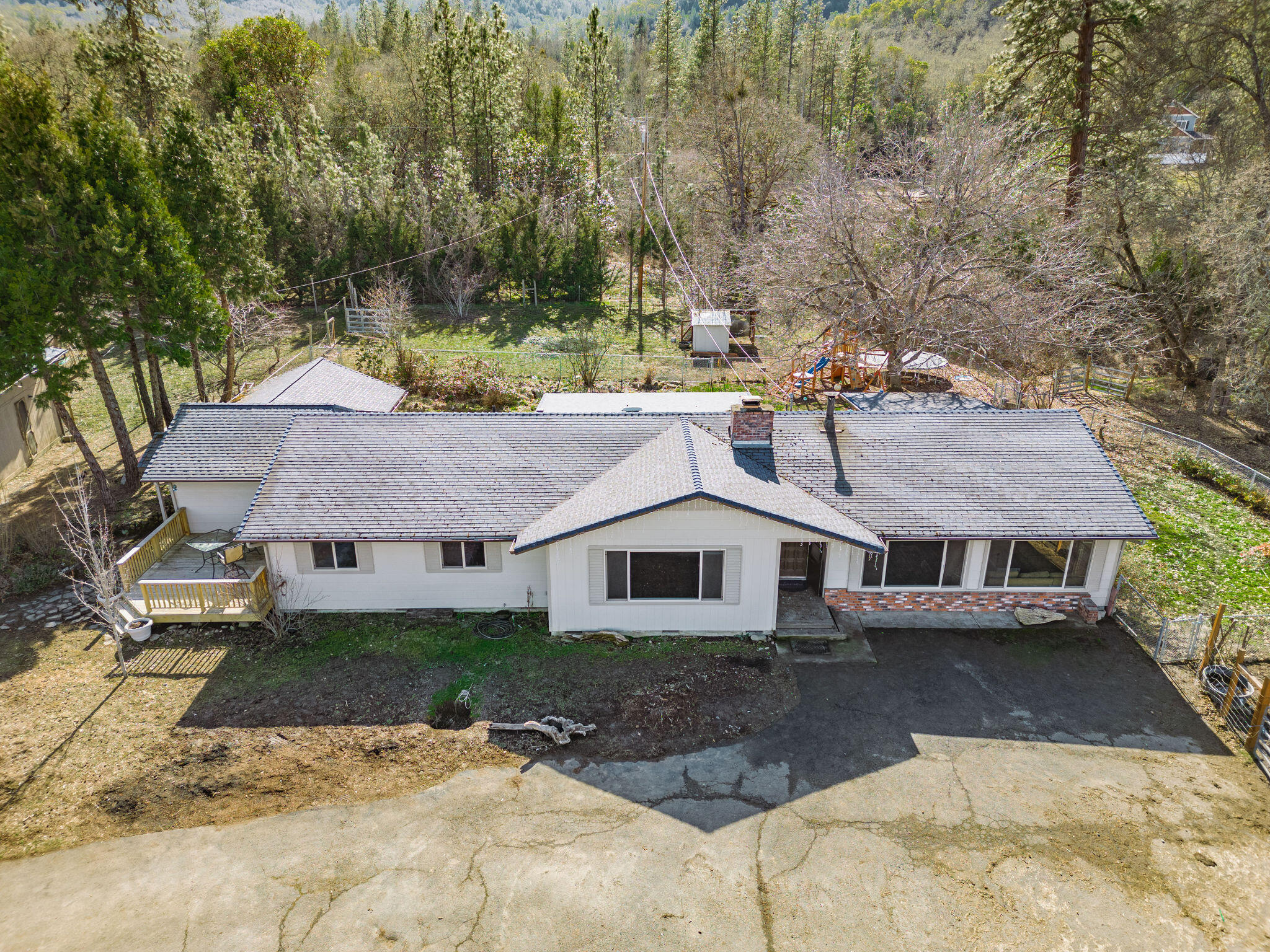6732 Old Stage Road Central Point, OR 97502 - Photo 2 of 51 a view of a white house with a yard plants and large tree