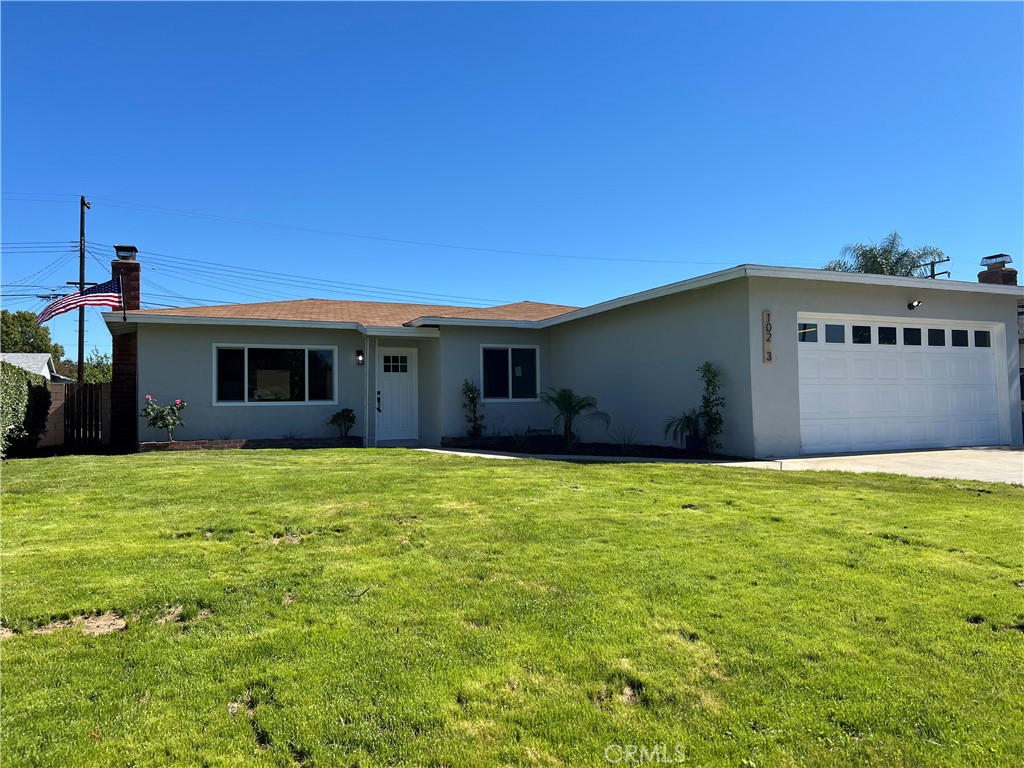 a view of an house with backyard space and balcony