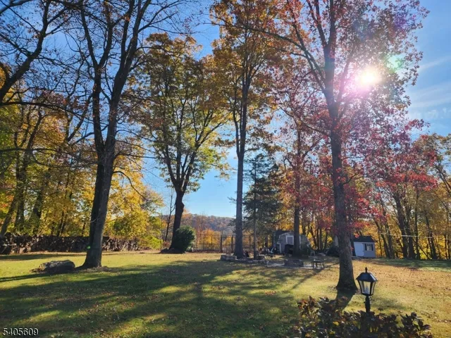 a view of a house with truck parked on a road