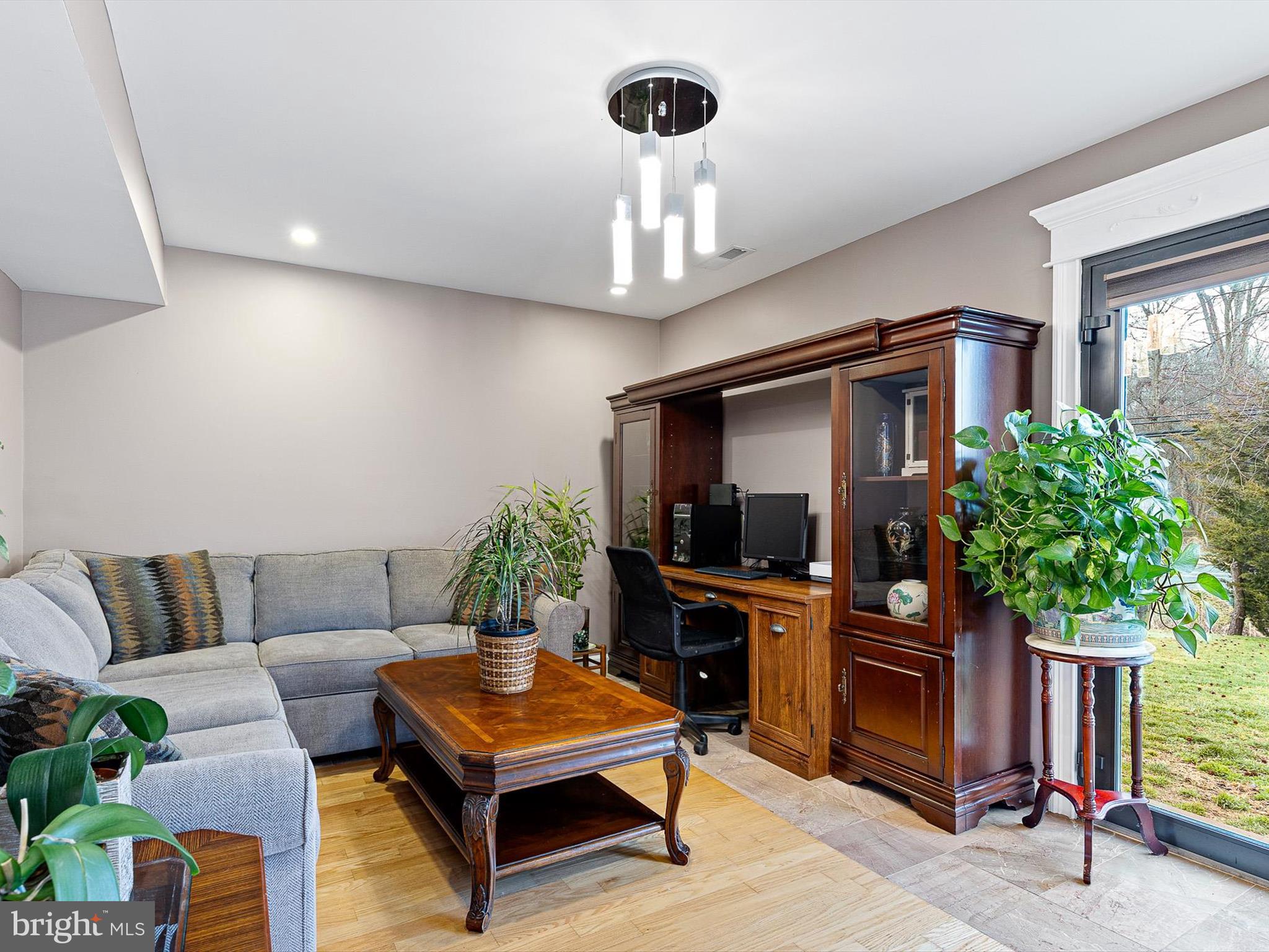46 Westbridge Road Bear, DE 19701 - Photo 19 of 25 a living room with furniture a chandelier and a flat screen tv