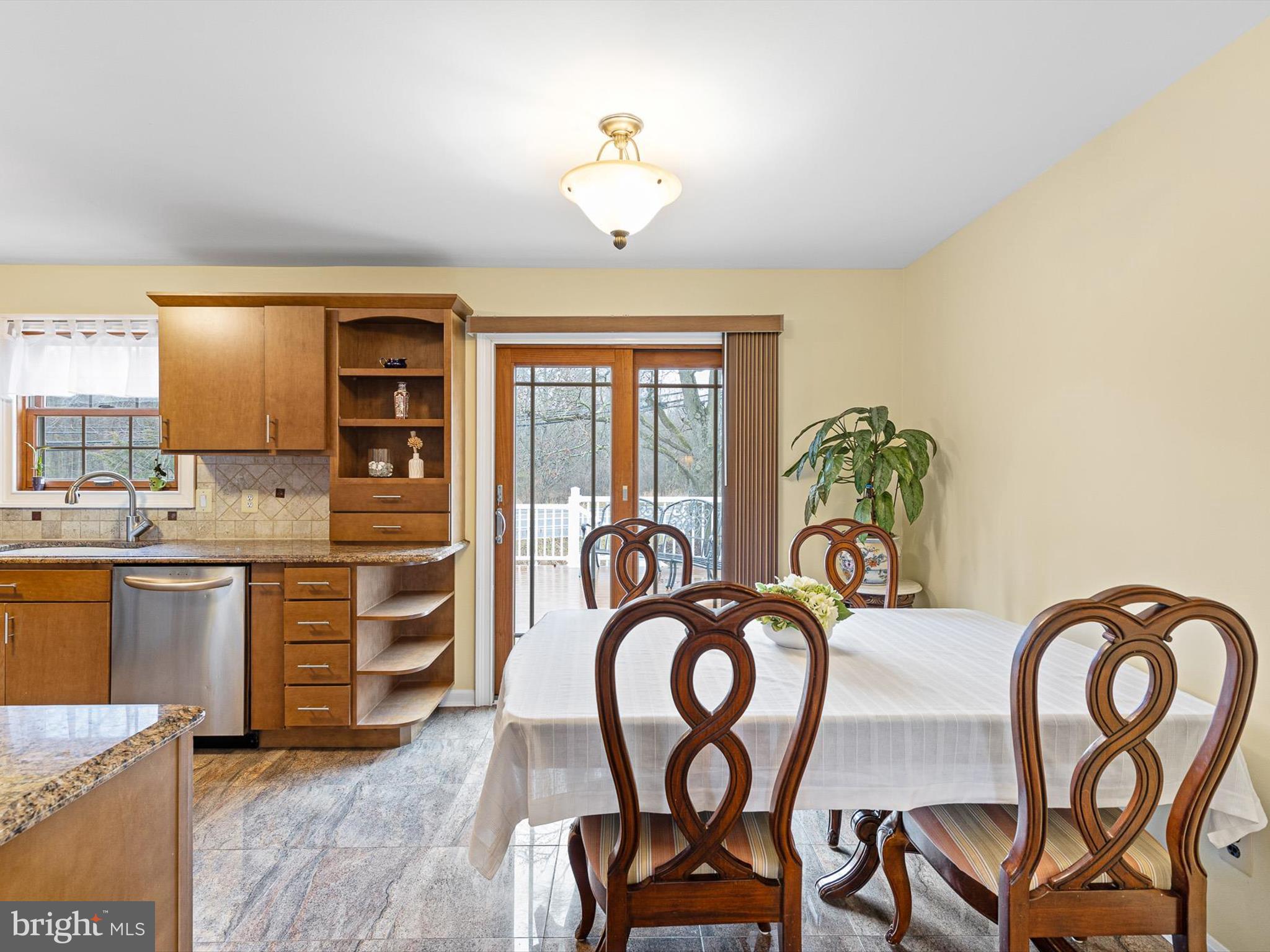 46 Westbridge Road Bear, DE 19701 - Photo 9 of 25 a very nice looking kitchen with granite countertop a stove top oven a sink and dishwasher