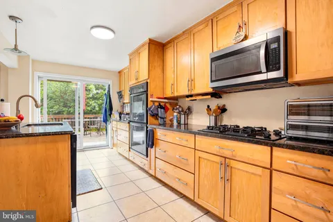 a kitchen with stainless steel appliances a sink stove and microwave