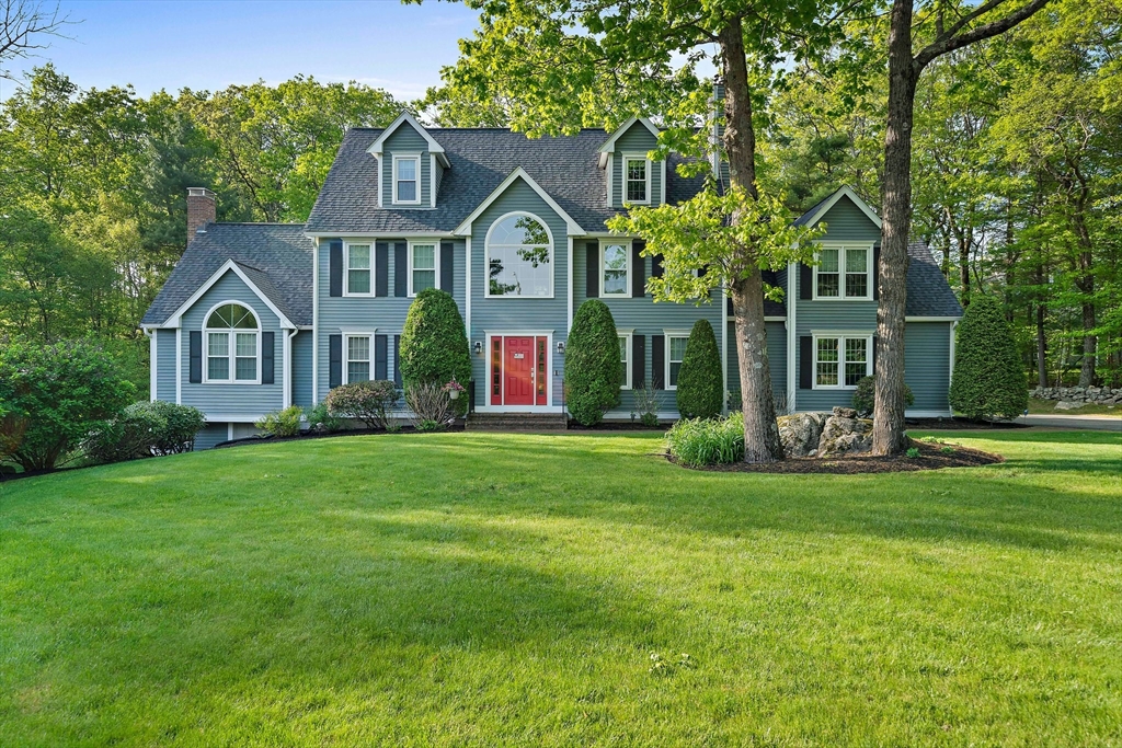 a front view of a house with a garden