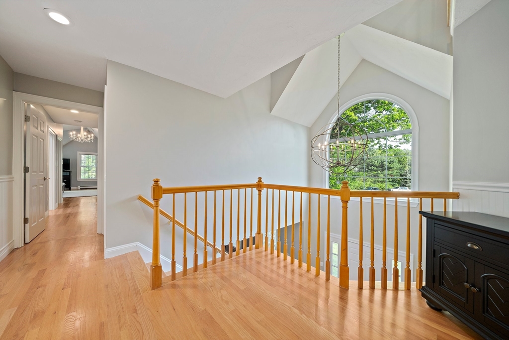 100 York Brook Road Canton, MA 02021 - Photo 22 of 42 a view of a hallway with wooden floor and a chandelier