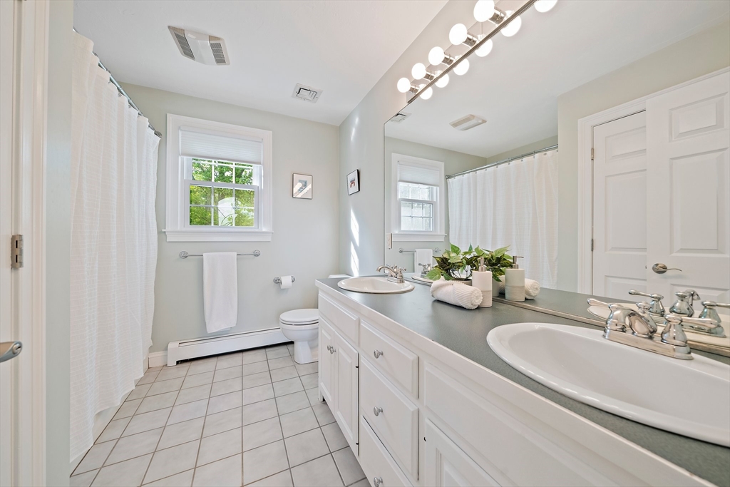 100 York Brook Road Canton, MA 02021 - Photo 29 of 42 a spacious bathroom with a double vanity sink a mirror and a bathtub