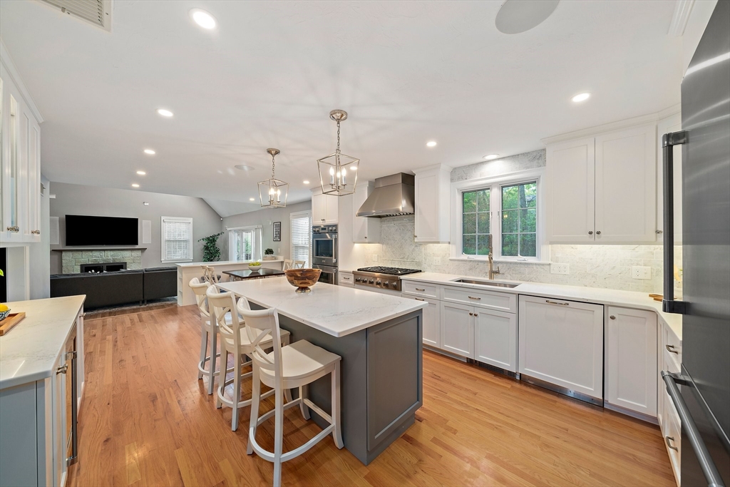 100 York Brook Road Canton, MA 02021 - Photo 6 of 42 a large kitchen with kitchen island a sink table and chairs