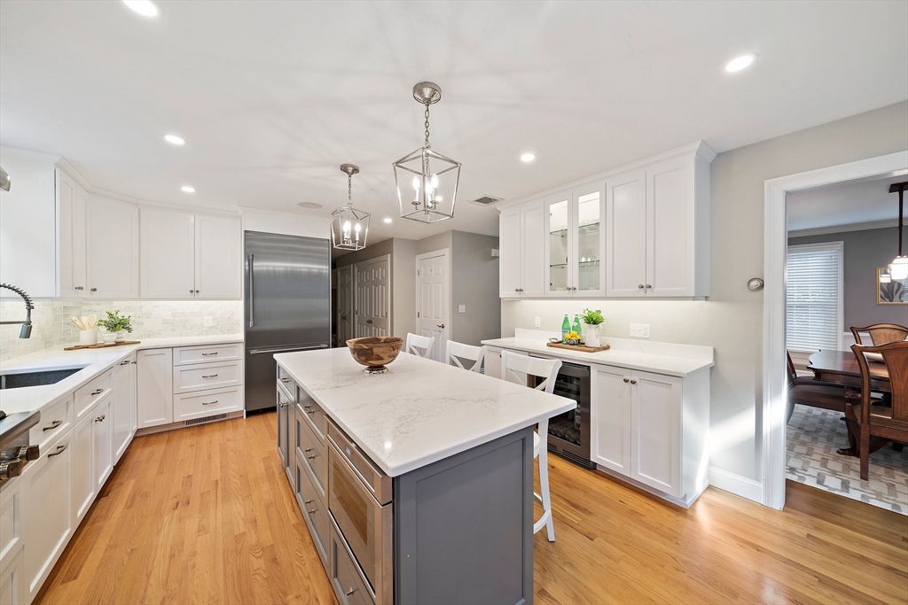 100 York Brook Road Canton, MA 02021 - Photo 9 of 42 a kitchen with a refrigerator a sink dishwasher a stove and white cabinets with wooden floor