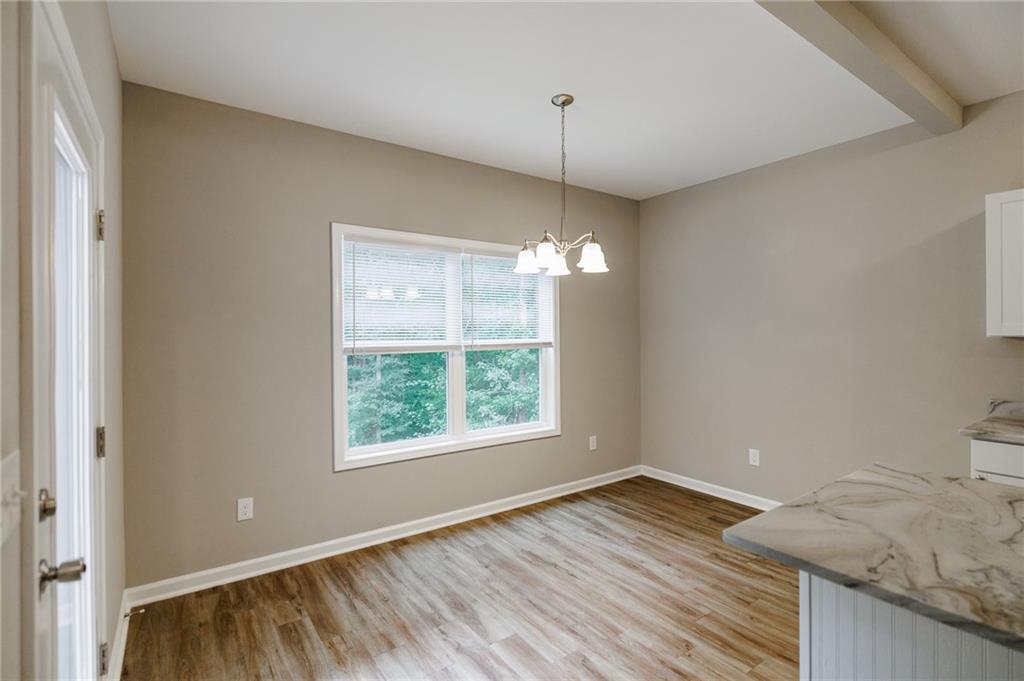 103 Three Rivers Court Hull, GA 30646 - Photo 13 of 40 a view of an empty room with wooden floor and a window