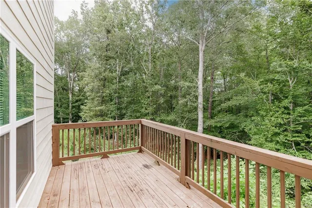 a view of balcony with deck and trees