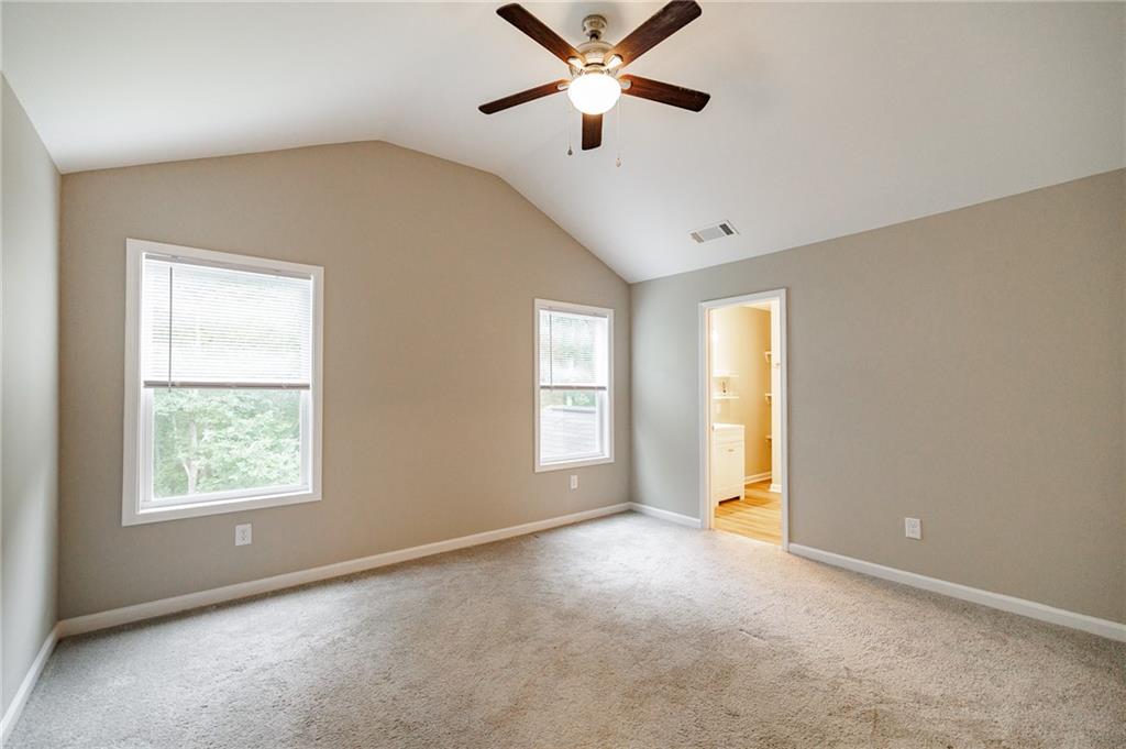 103 Three Rivers Court Hull, GA 30646 - Photo 21 of 40 a view of a big room with windows and chandelier fan