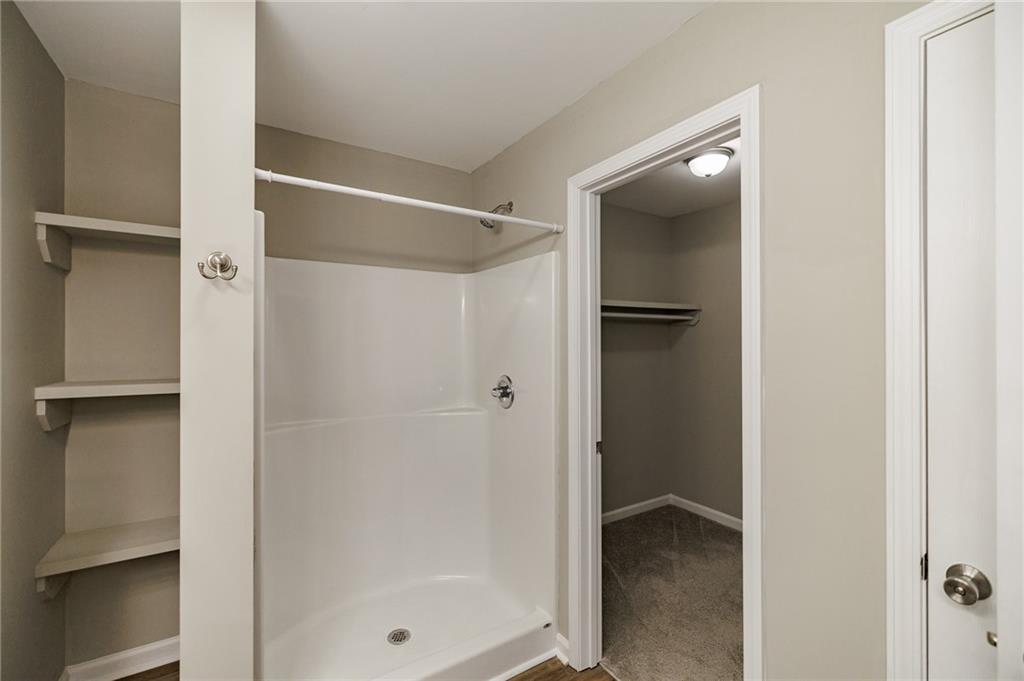 103 Three Rivers Court Hull, GA 30646 - Photo 24 of 40 a bathroom with a glass shower door