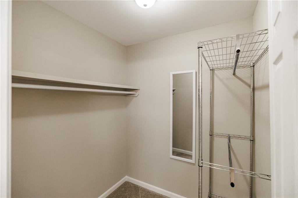 103 Three Rivers Court Hull, GA 30646 - Photo 26 of 40 a view of walk in closet with empty racks