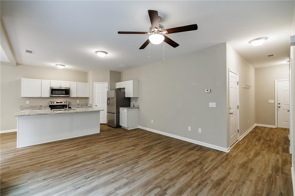 103 Three Rivers Court Hull, GA 30646 - Photo 8 of 40 a view of kitchen with refrigerator microwave and stove