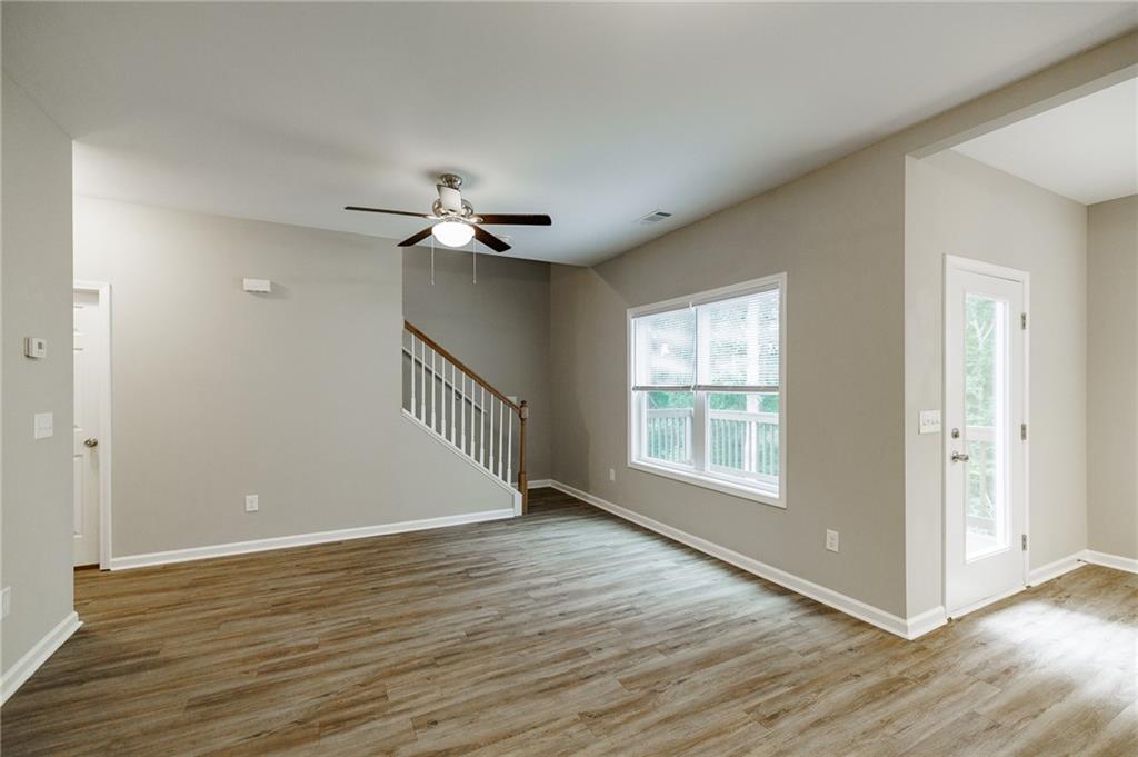 103 Three Rivers Court Hull, GA 30646 - Photo 9 of 40 a view of an empty room with wooden floor and a window