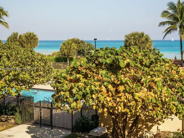 a kitchen with granite countertop kitchen island stainless steel appliances a dining table and chairs
