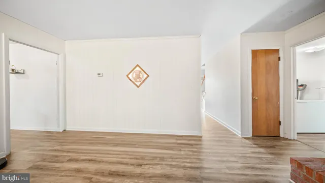 a view of a room with wooden floor