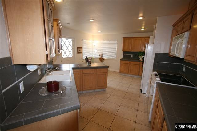 1701 Berkeley Drive Reno, NV 89509 - Photo 2 of 9 a kitchen with stainless steel appliances a sink stove and cabinets