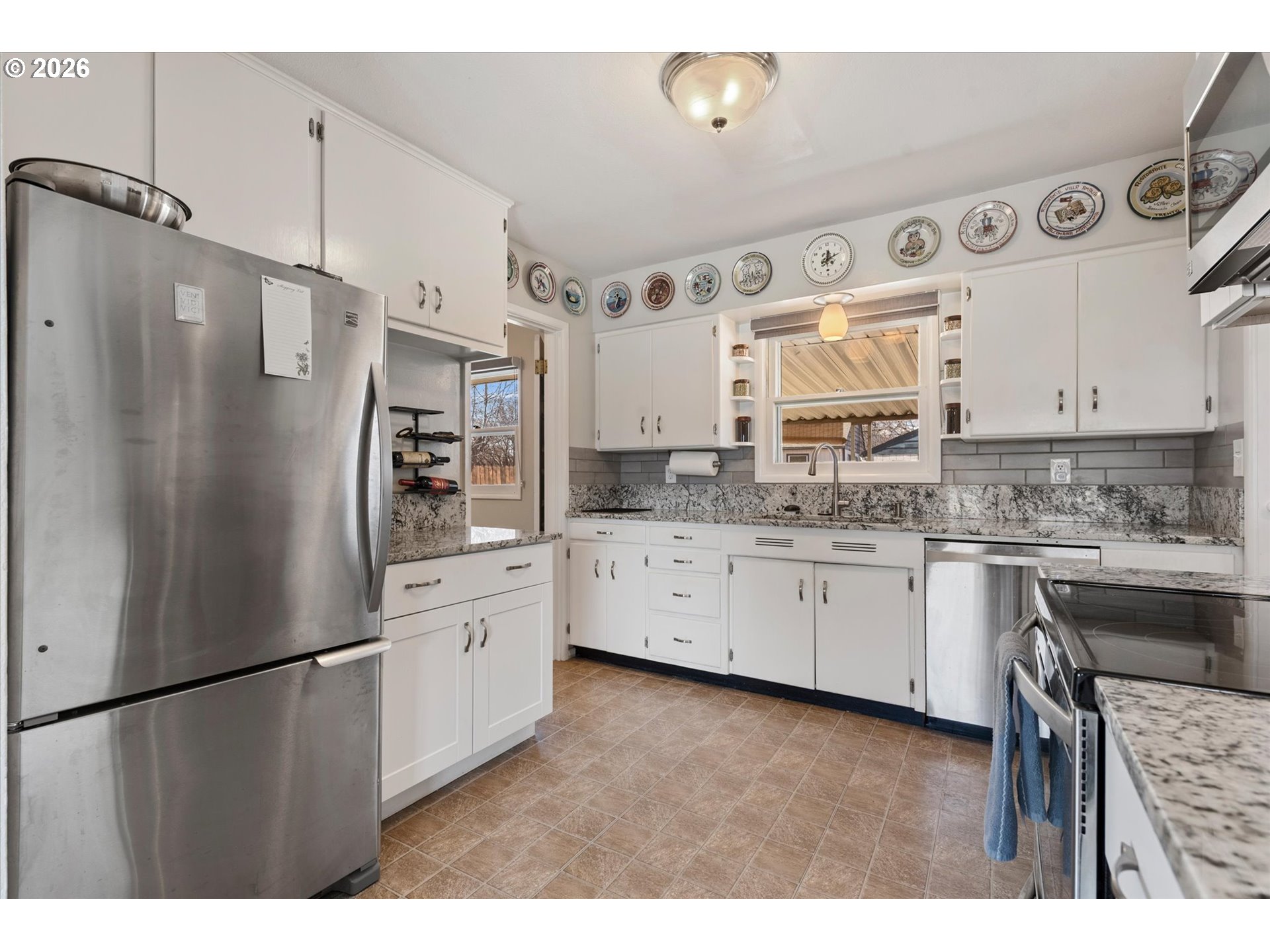 2975 North 3rd Street Baker City, OR 97814 - Photo 11 of 48 a kitchen with stainless steel appliances a refrigerator sink and cabinets