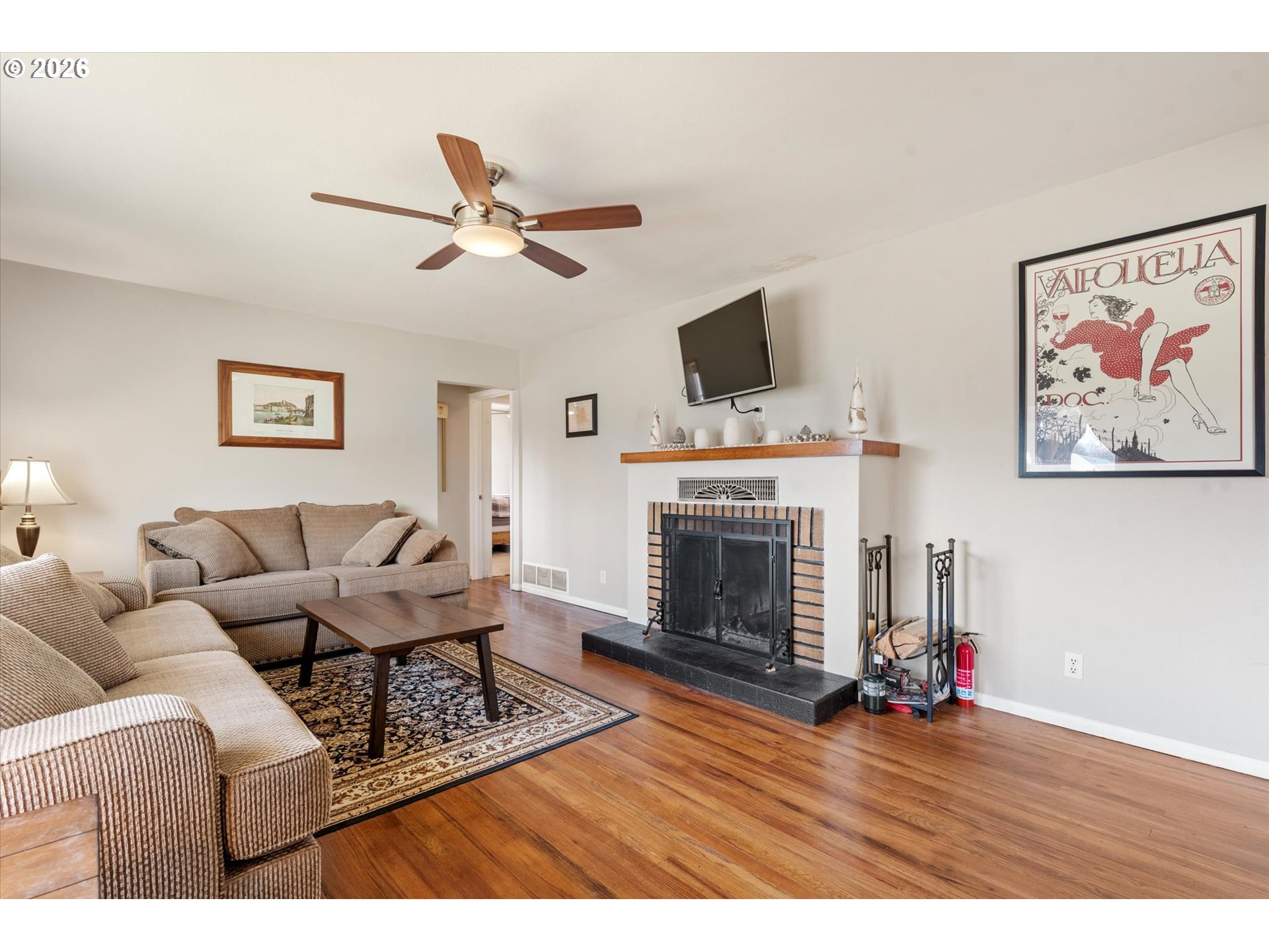 2975 North 3rd Street Baker City, OR 97814 - Photo 5 of 48 a living room with furniture a flat screen tv and a fireplace